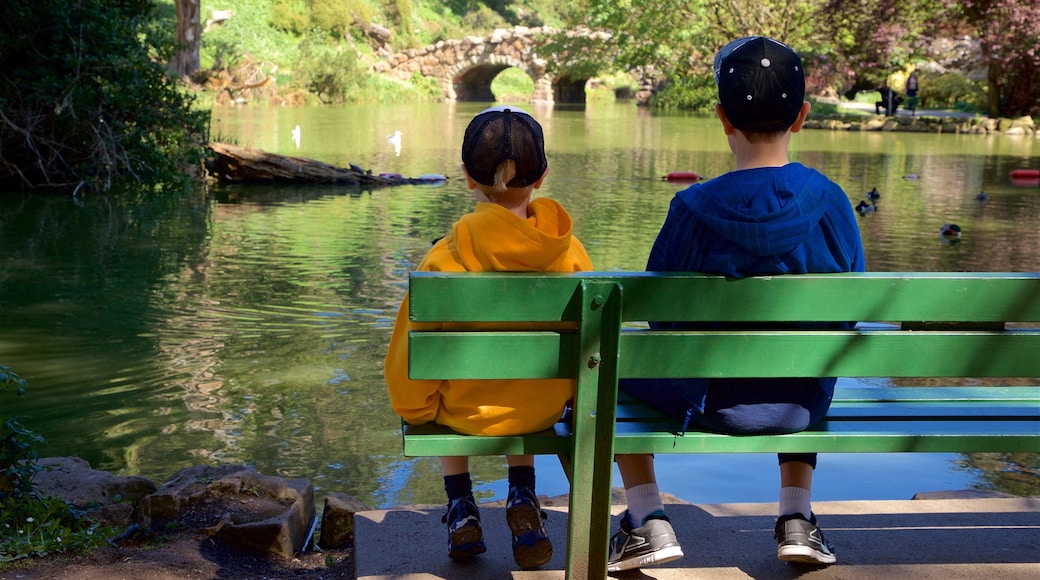 Stow Lake featuring a river or creek as well as children