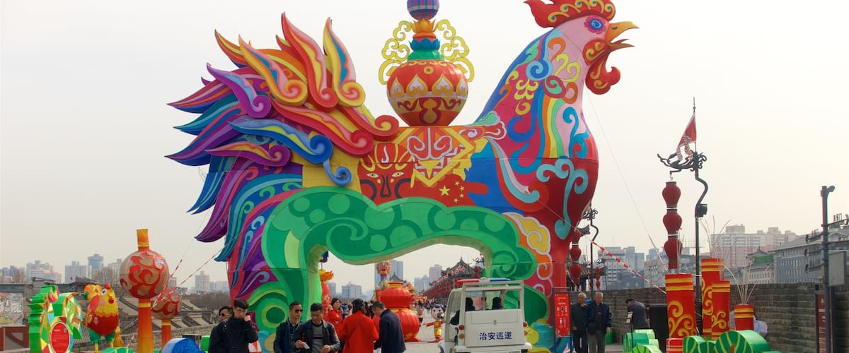 Xi\'an City Walls showing outdoor art and a city as well as a small group of people