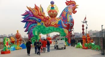 Xi\'an City Walls showing outdoor art and a city as well as a small group of people