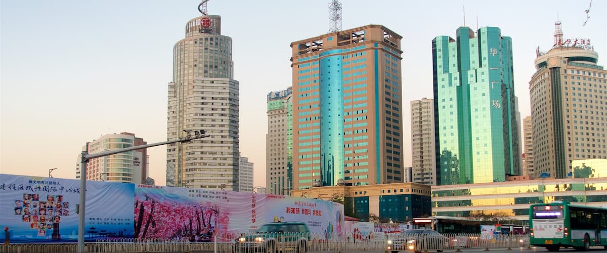 Kunming showing a high rise building, a sunset and a city