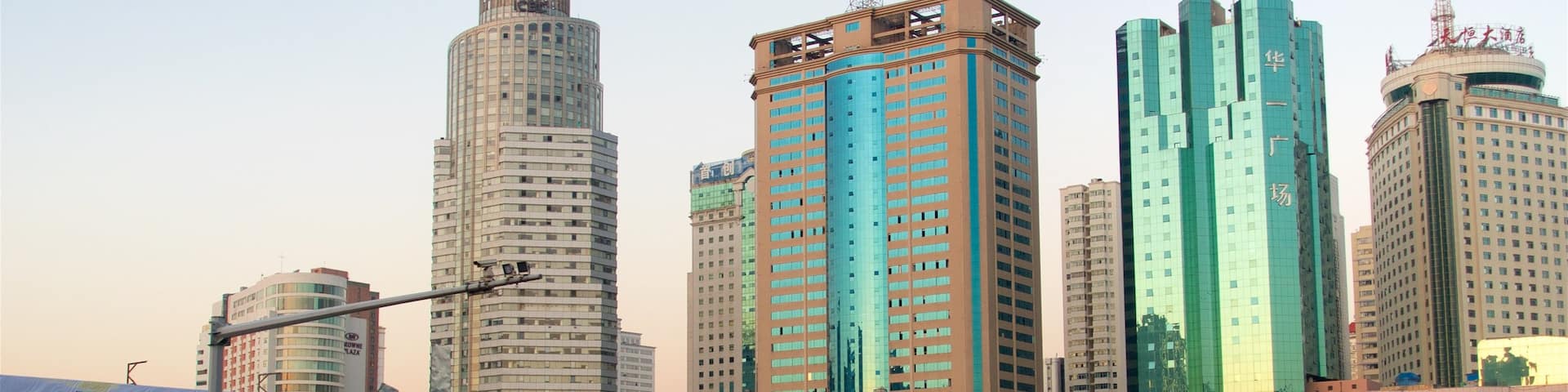 Kunming showing a high rise building, a sunset and a city