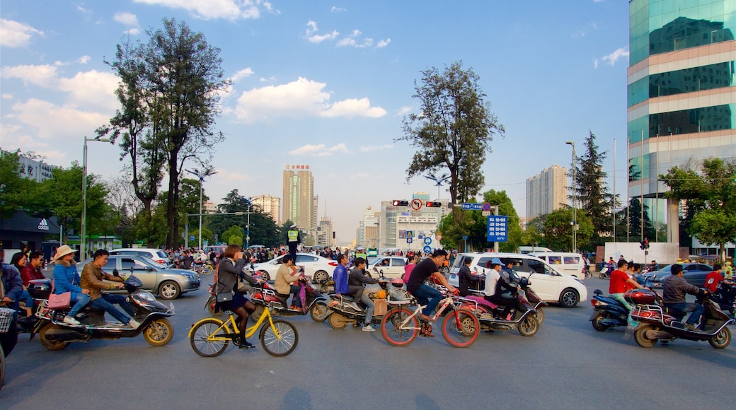 Kunming showing a sunset, a city and cycling