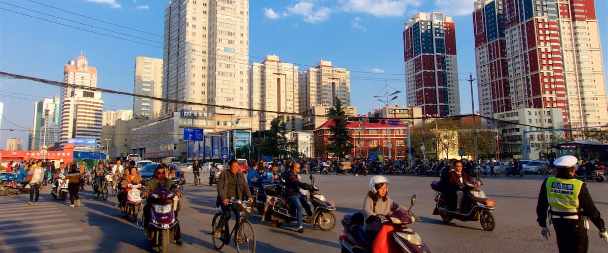 Kunming showing a city, a sunset and cycling