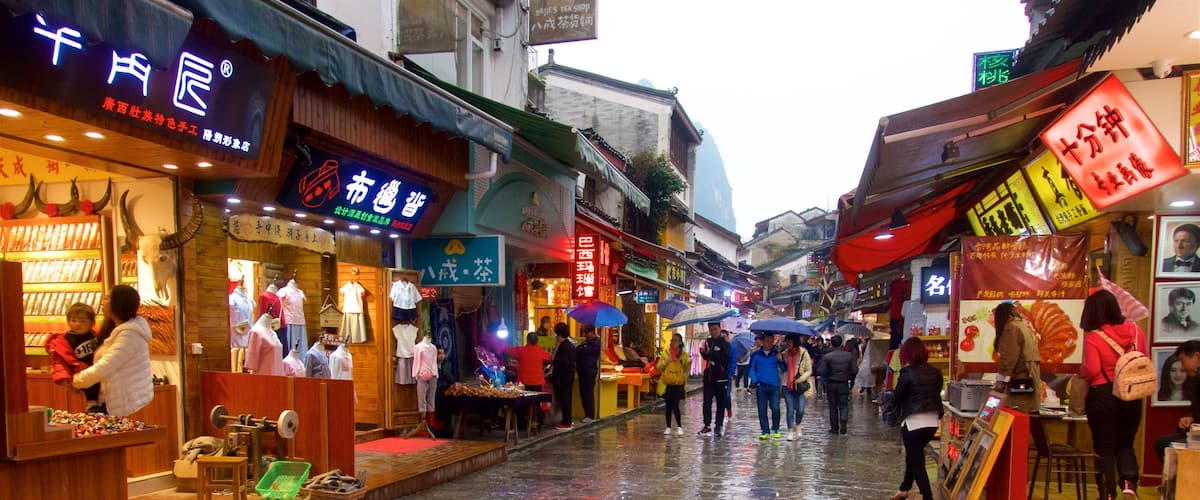 Yangshuo which includes markets as well as a small group of people