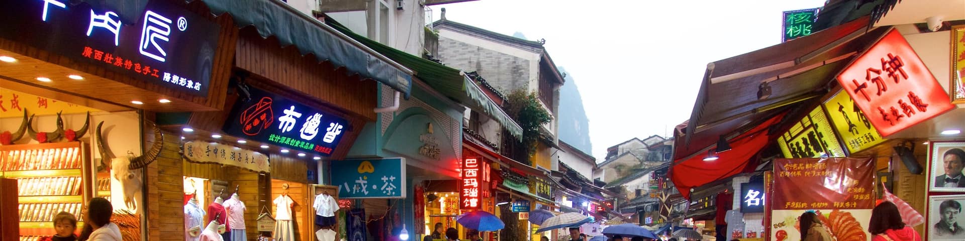 Yangshuo featuring markets as well as a small group of people