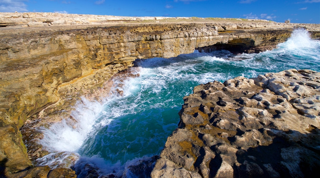 Devil\'s Bridge showing waves, rocky coastline and general coastal views