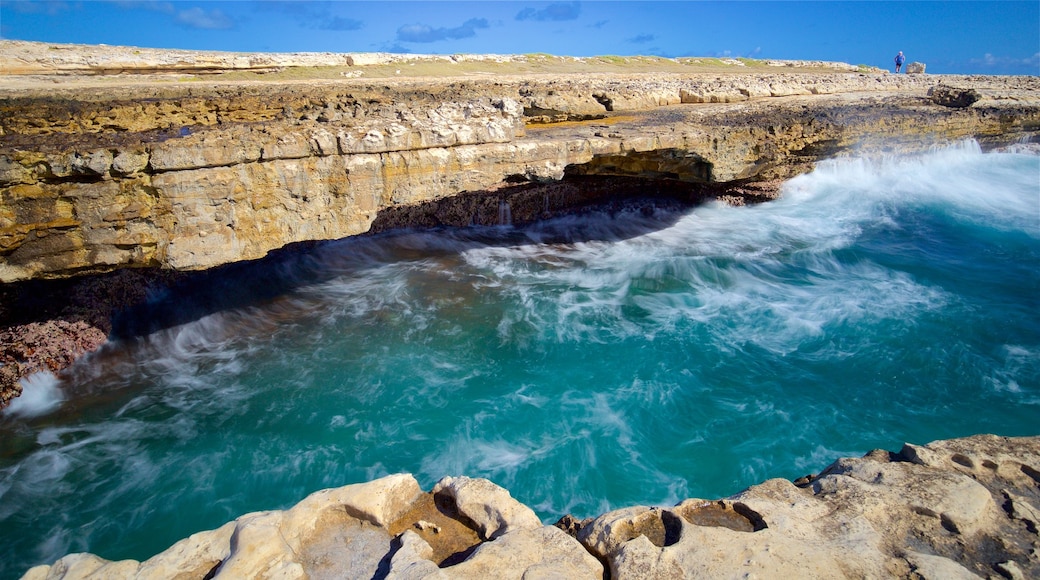 Devil\'s Bridge which includes rocky coastline, waves and general coastal views