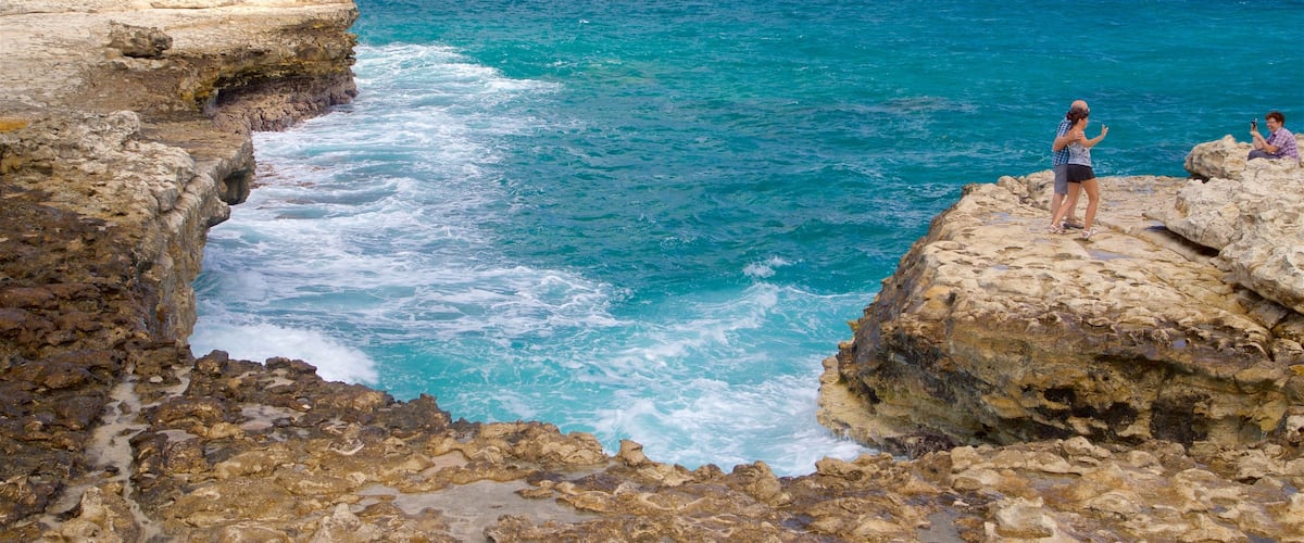 Devil\'s Bridge showing waves, rocky coastline and general coastal views