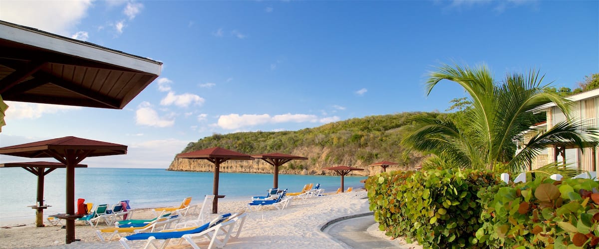 Dickenson Bay Beach showing tropical scenes, general coastal views and rocky coastline