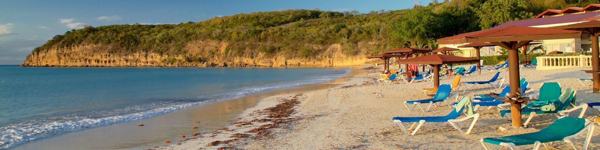 Dickenson Bay Beach showing rocky coastline, general coastal views and a sandy beach