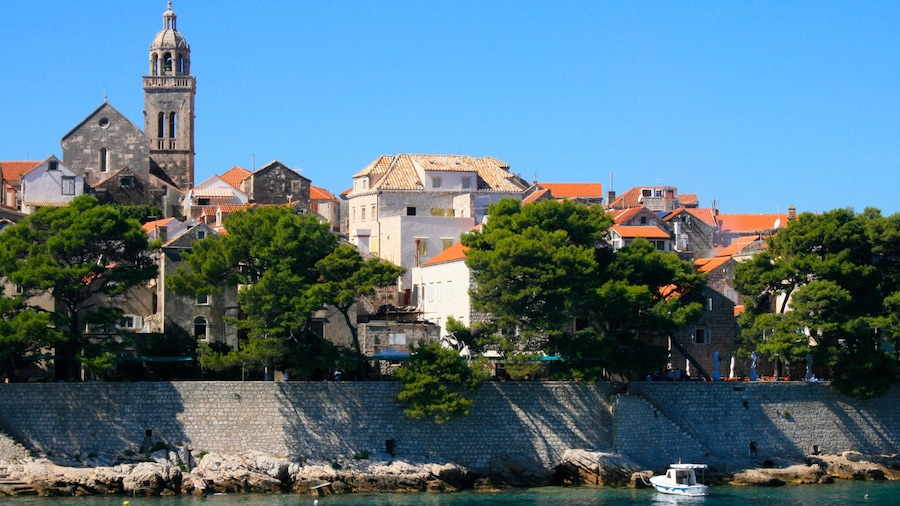 Korcula which includes a lake or waterhole and a small town or village