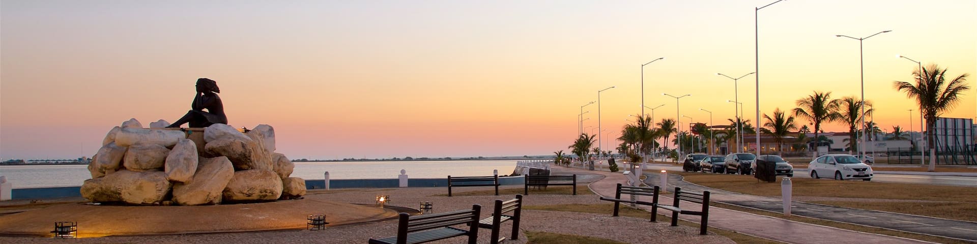 Novia del Mar Monument which includes a garden, outdoor art and a sunset