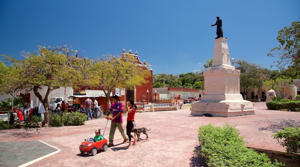 Lerma featuring a statue or sculpture and a garden as well as a family