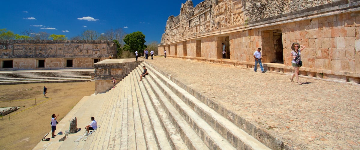 Uxmal Archaeological Site featuring heritage elements as well as a small group of people