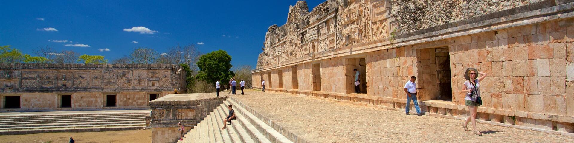 Uxmal Archaeological Site featuring heritage elements as well as a small group of people