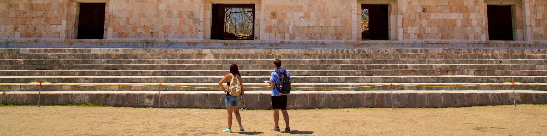 Uxmal Archaeological Site showing heritage elements as well as a couple