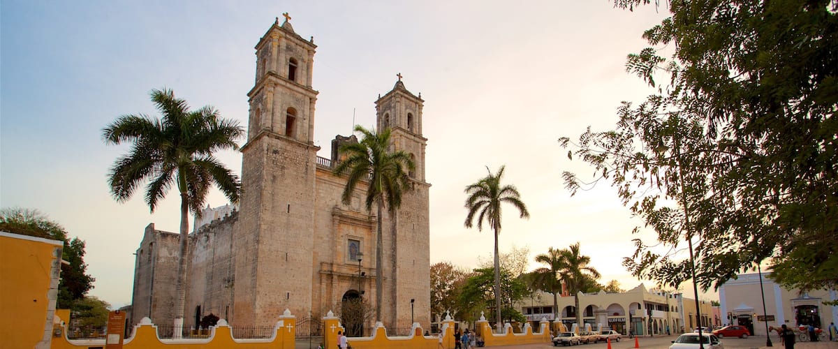 Cathedral of San Gervasio featuring heritage architecture and a sunset