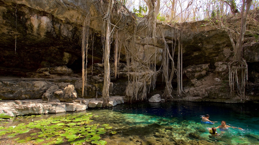 Cenote X\'batun showing a lake or waterhole and swimming as well as a small group of people