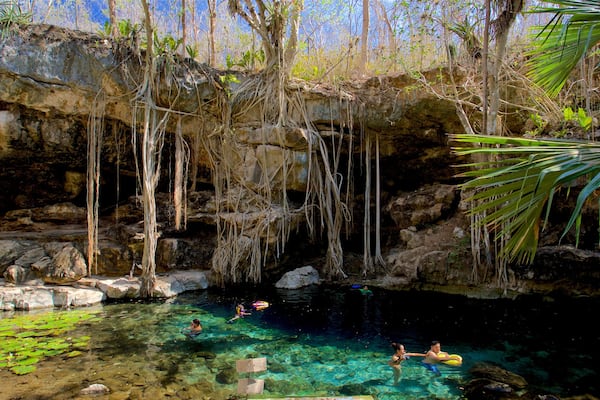 Cenote X\'batun which includes swimming and a lake or waterhole as well as a small group of people