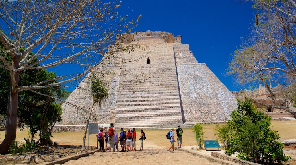 Pyramid of the Magician featuring heritage architecture as well as a small group of people