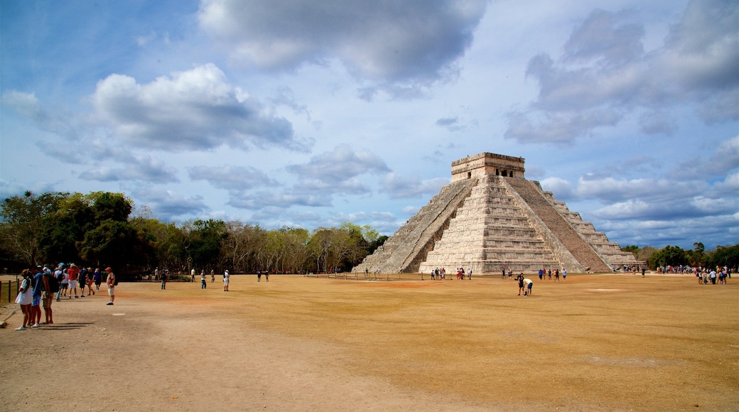 Pyramid of Kukulkan which includes heritage architecture as well as a small group of people