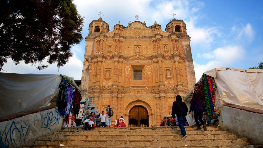 Templo de Santo Domingo showing a church or cathedral and heritage architecture as well as a small group of people