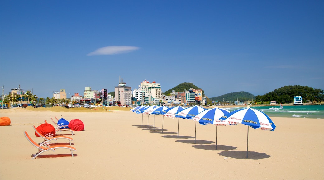 Songjeong Beach which includes a sandy beach, a coastal town and general coastal views