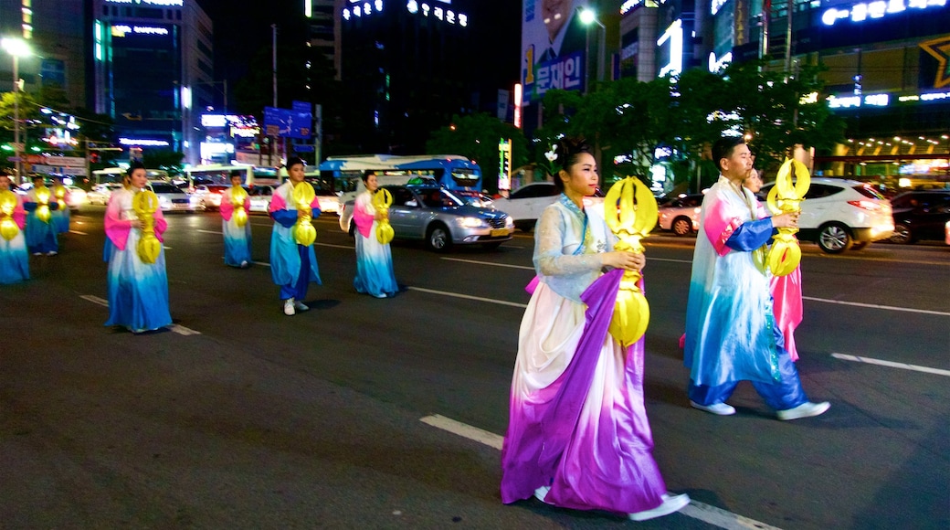 Busanjin showing street performance and night scenes as well as a small group of people