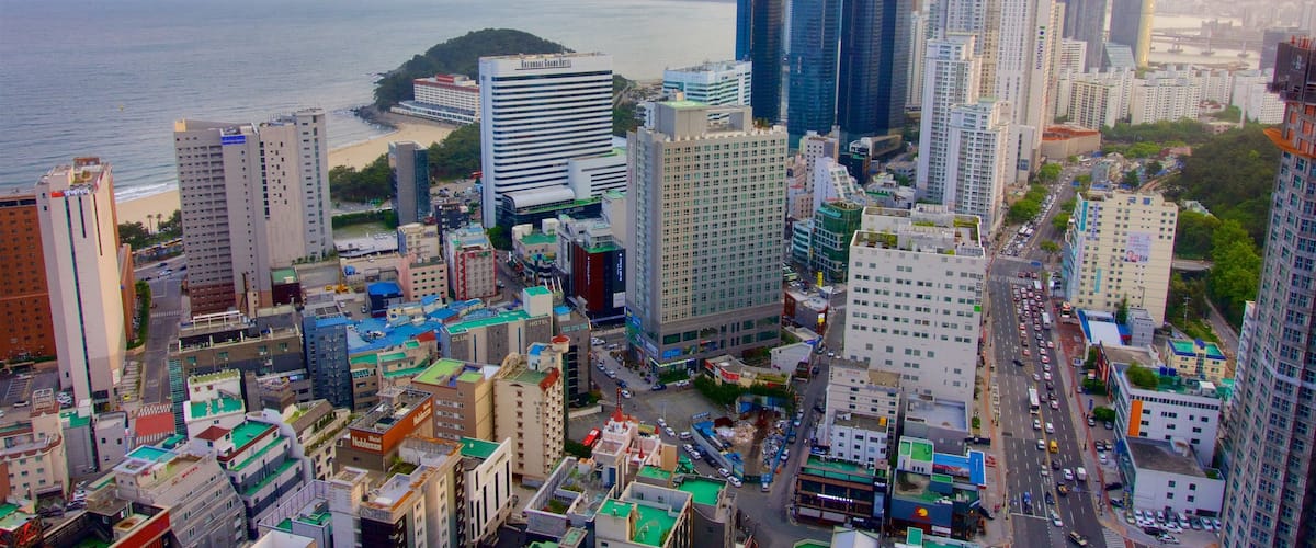 Haeundae which includes general coastal views, a sunset and a coastal town