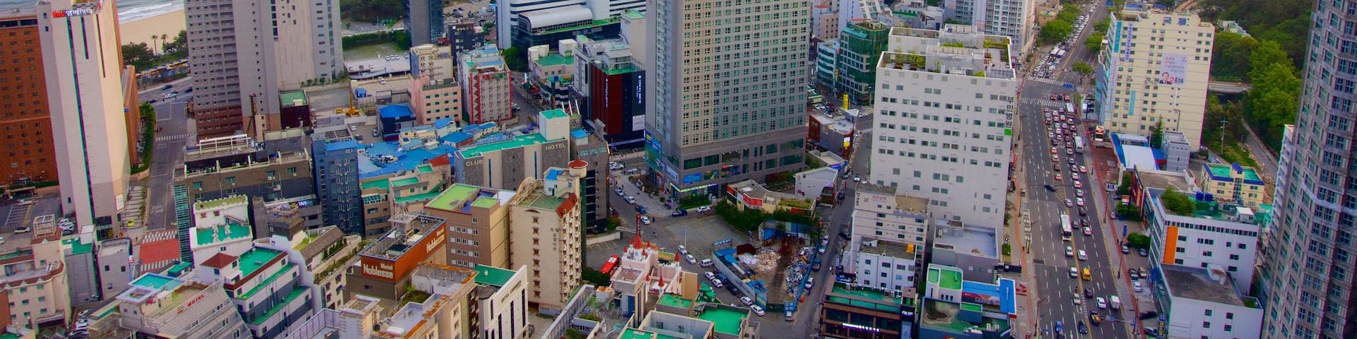 Haeundae which includes general coastal views, a sunset and a coastal town