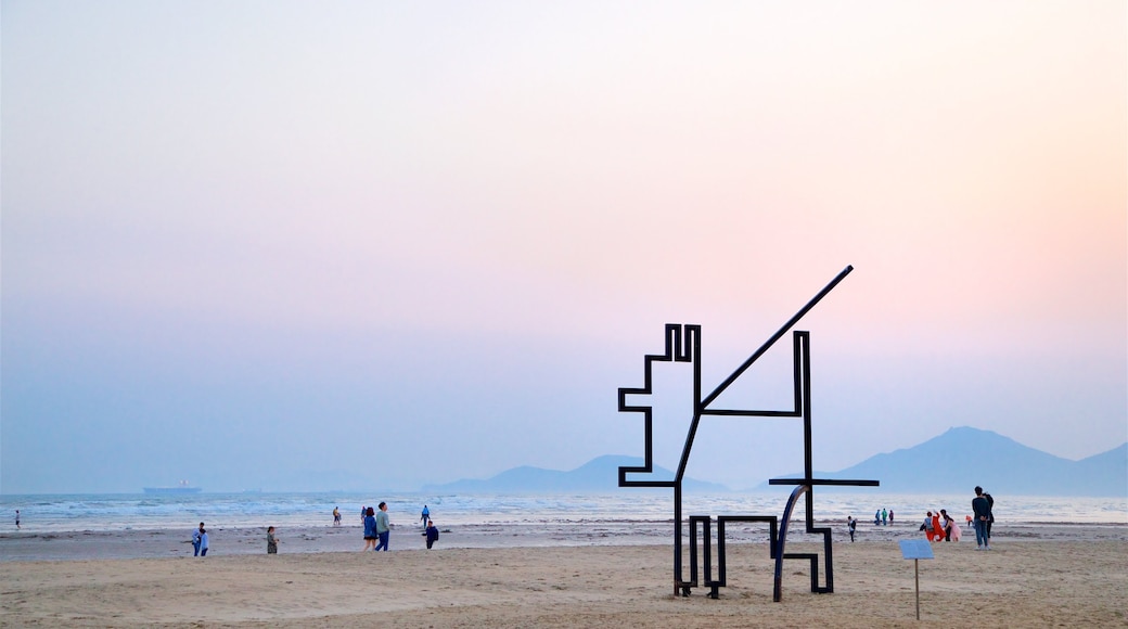 Dadaepo Beach showing a sandy beach, a sunset and outdoor art