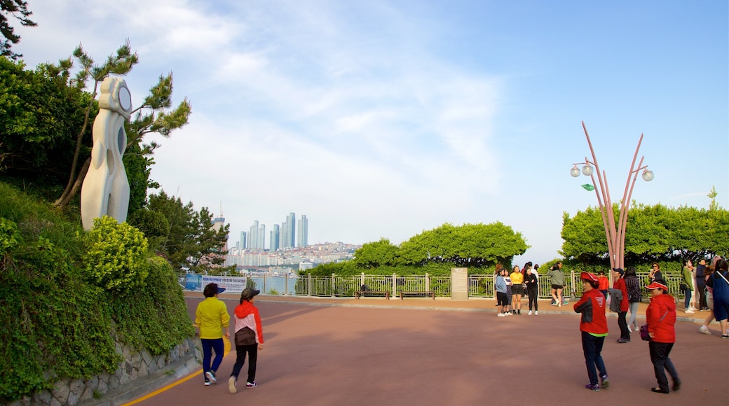 Dongbaekseom Park featuring a park and a city as well as a small group of people