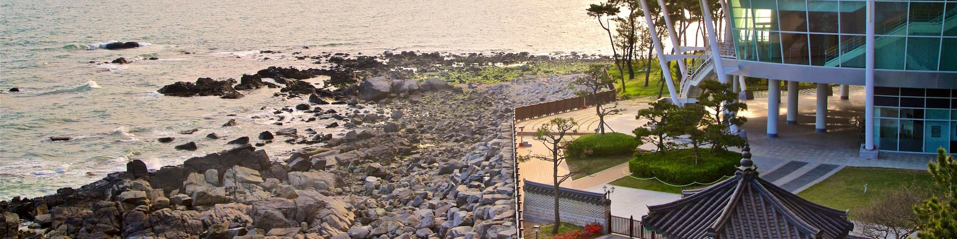 APEC Naru Park which includes a sunset, rugged coastline and a bridge