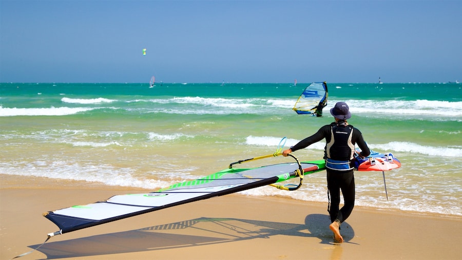 Songjeong Beach showing general coastal views, kite surfing and a sandy beach