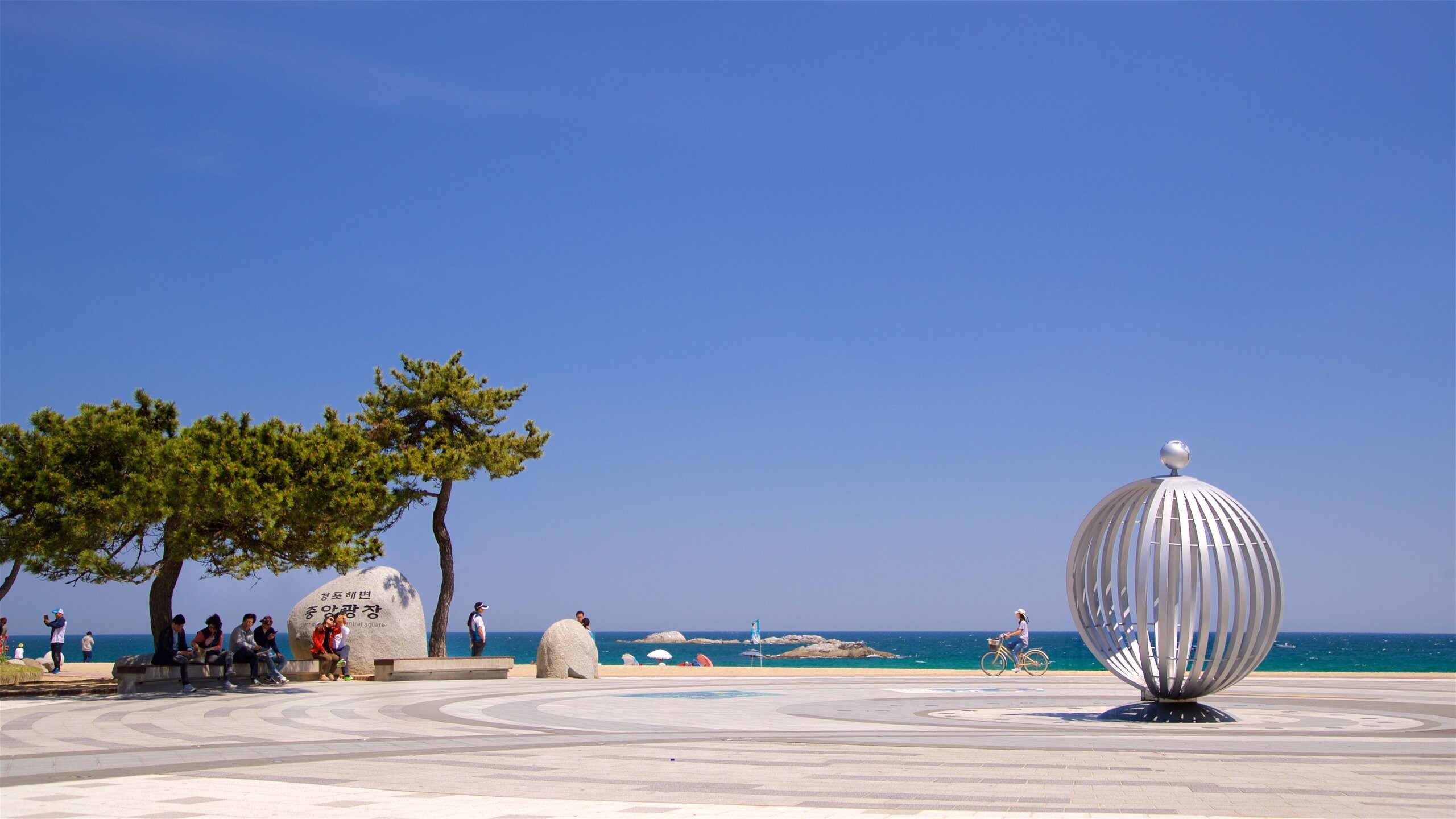 Pyeongchang featuring outdoor art and general coastal views as well as a small group of people