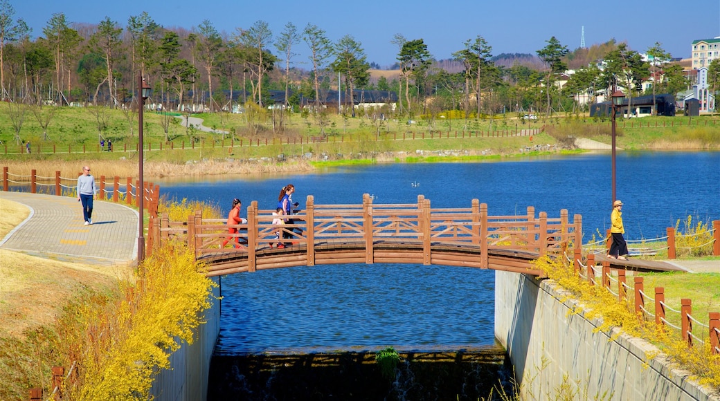 Alpensia Ski Resort showing a bridge and a river or creek as well as a family