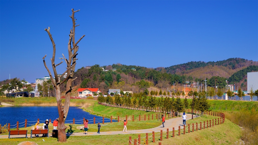 Alpensia Ski Resort featuring a garden and a lake or waterhole as well as a small group of people
