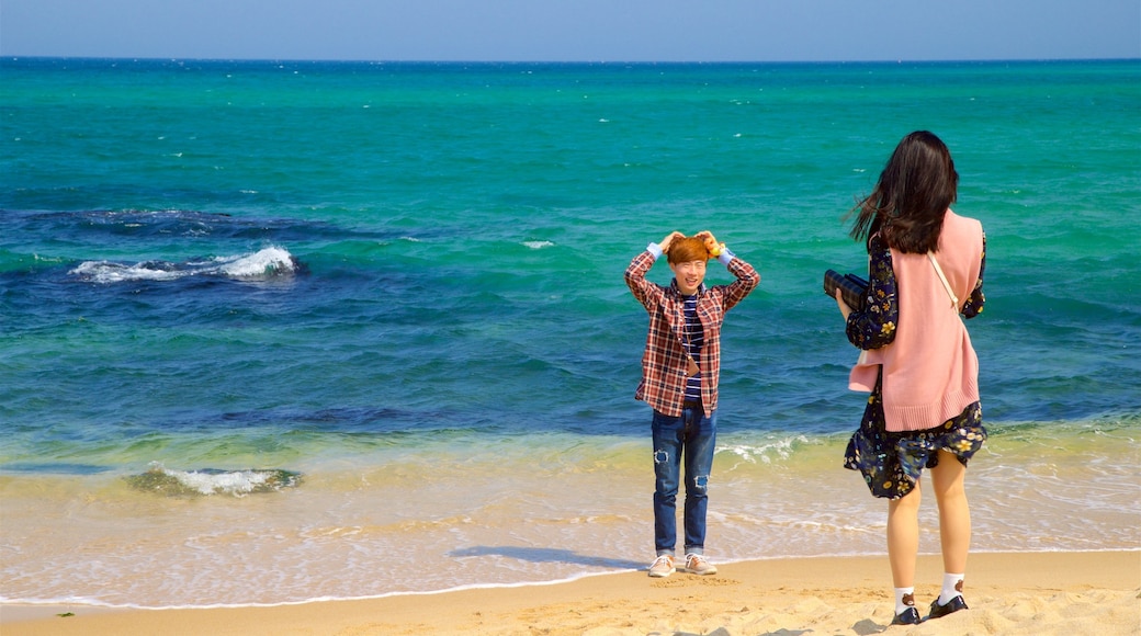 Jeongdongjin Beach which includes a beach and general coastal views as well as a couple