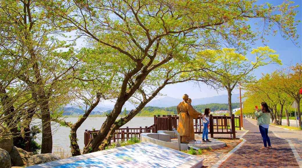 Pyeongchang featuring a lake or waterhole and a statue or sculpture as well as a couple