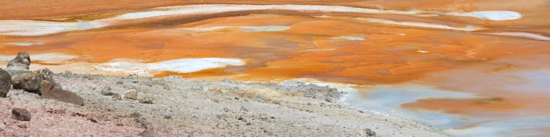 Norris Geyser Basin which includes a hot spring, landscape views and mist or fog