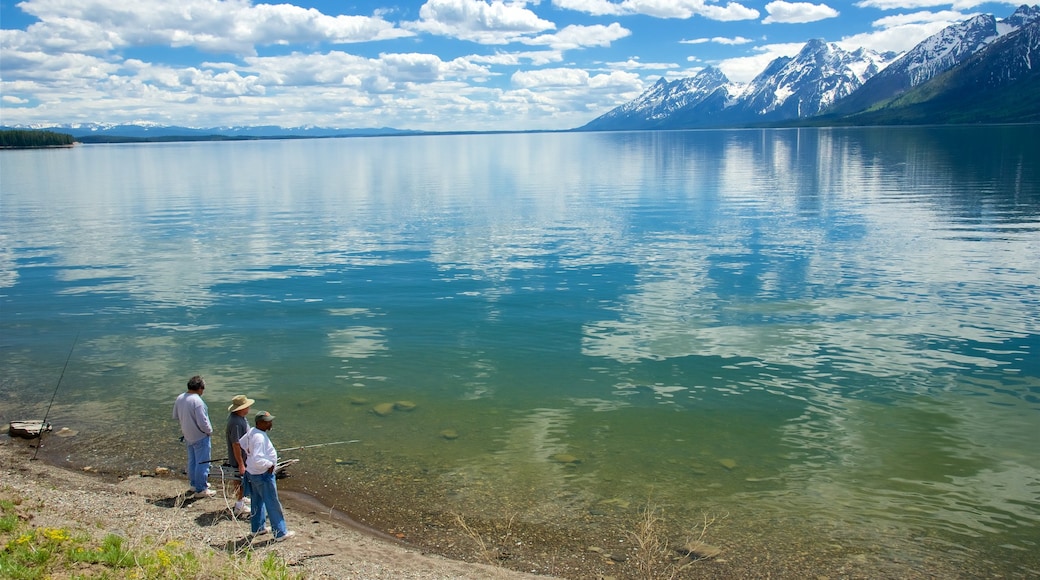 Jackson Lake showing fishing and a lake or waterhole as well as a small group of people