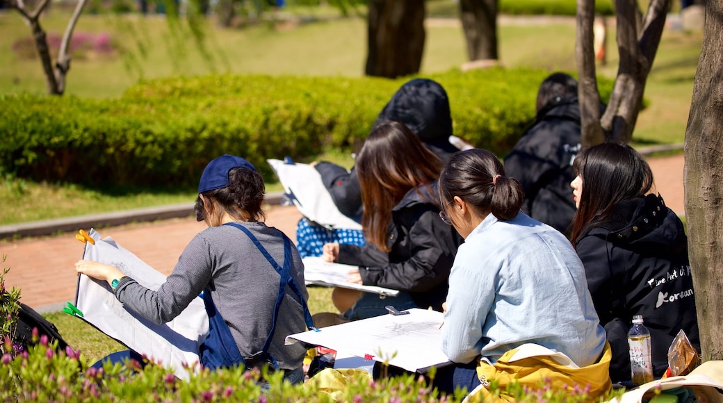 Suwon which includes a park as well as a small group of people