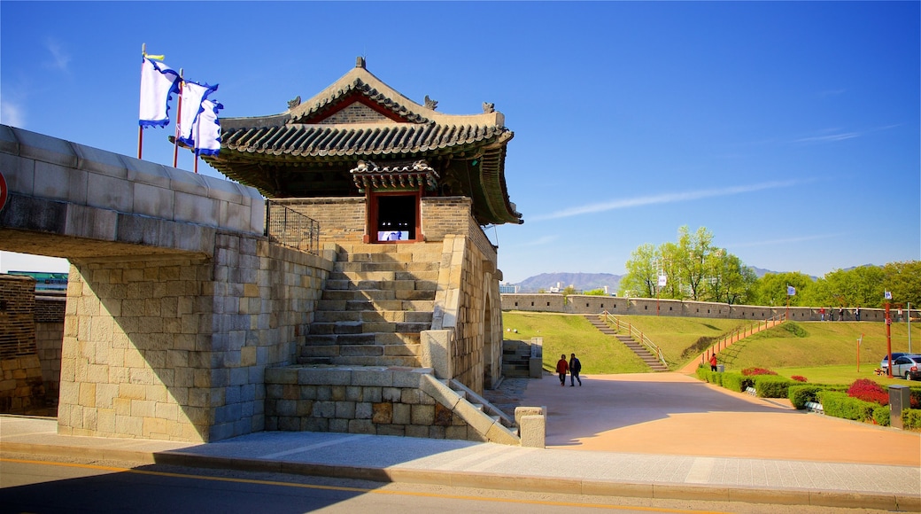 Hwaseomun Gate featuring a bridge, heritage elements and a park