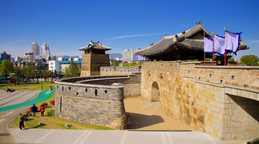 Hwaseomun Gate showing a garden, a city and heritage elements