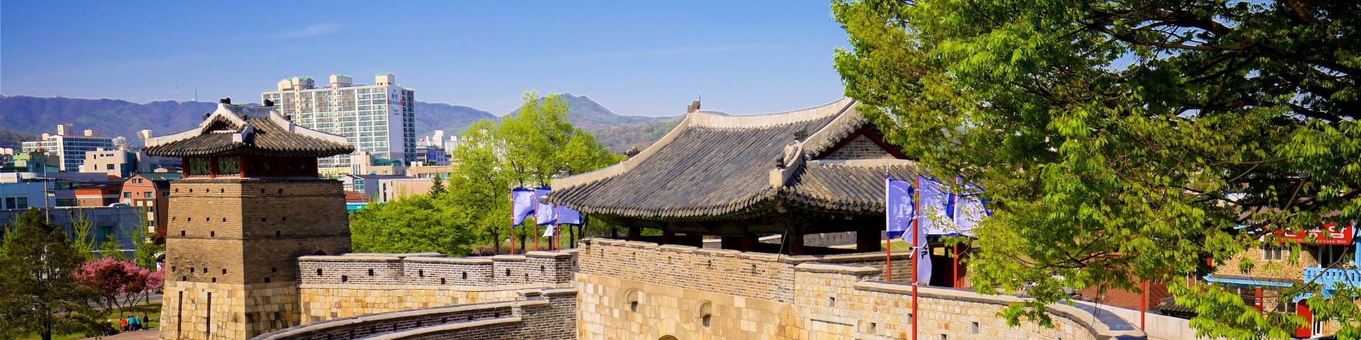 Hwaseomun Gate featuring heritage elements, a park and a city
