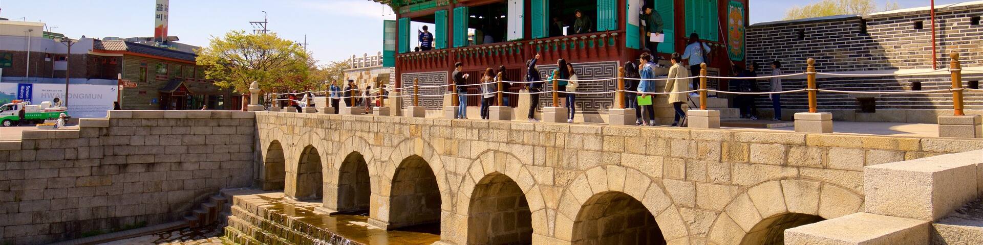 Hwahongmun Gate showing a river or creek, a bridge and heritage architecture