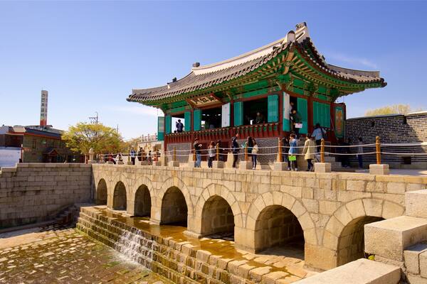 Hwahongmun Gate which includes a river or creek, a bridge and heritage architecture