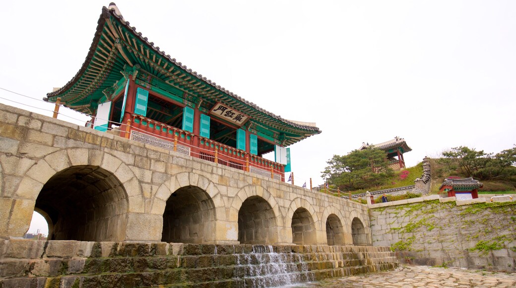 Hwahongmun Gate featuring a bridge, heritage architecture and a river or creek