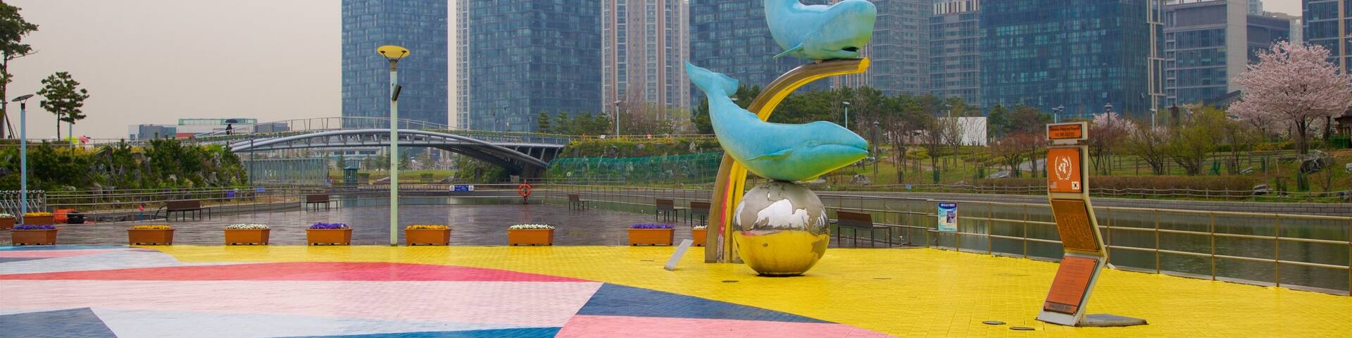 Songdo Central Park showing a high rise building, a river or creek and outdoor art