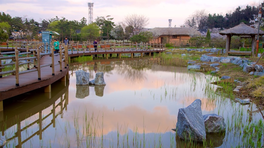 Wolmi Traditional Park which includes a park, a pond and a sunset